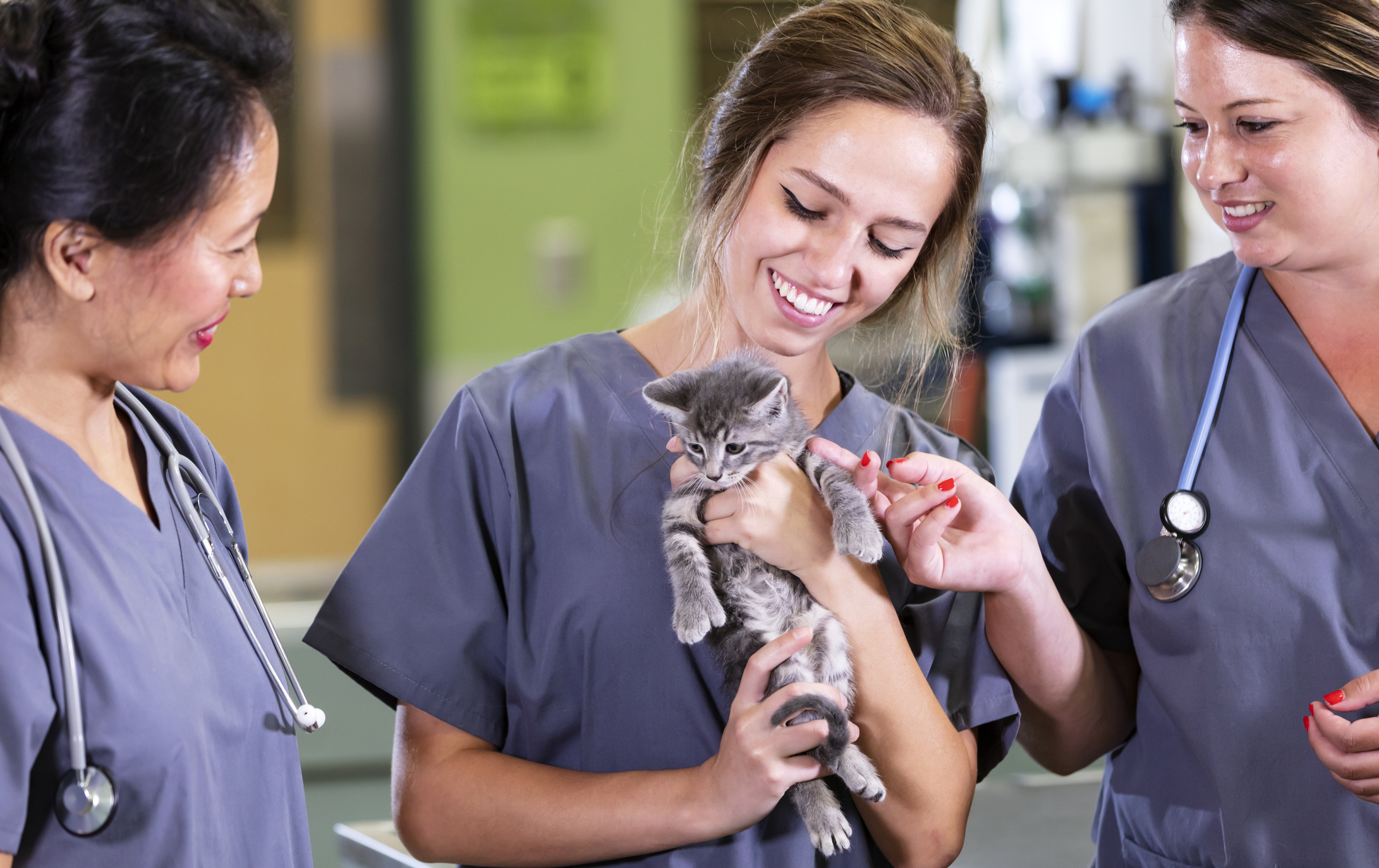 Community pet-care supporters smiling while caring for a pet